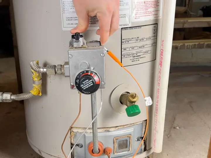 Technician working on a gas water heater during emergency hot water heater repair in Revere, MA