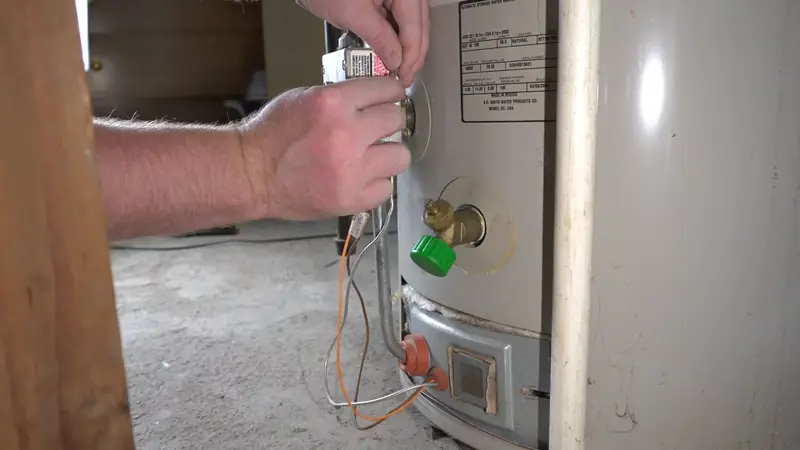 Revere Water Heater Pros technician checking a gas water heater on a service call